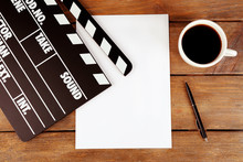 Movie Clapper With Paper, Pen And Cup Of Coffee