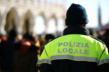 Wall Mural - Italian policeman with police uniform patrol in venice