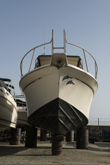 white boat on repairing dock