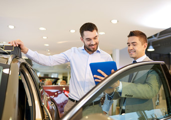 Wall Mural - happy man with car dealer in auto show or salon