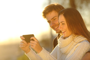 Sticker - Couple watching media videos in a smart phone