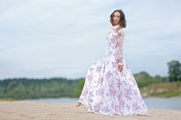 Wall Mural - beautiful elegant brunette girl in a field