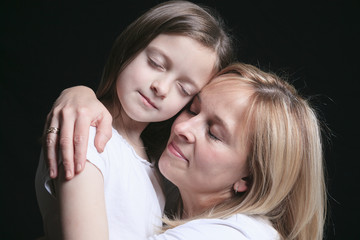  A mother with is daughter over dark background