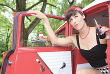 A Retro Girl With A Beautiful Red Old Car.