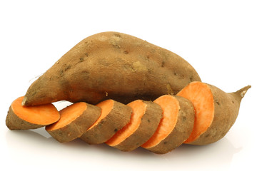 Wall Mural - one whole sweet potato and a cut one on a white background