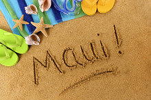The Word Maui Written In Sand On A Beach With Towel Flip Flops Seashells Hawaii Summer Vacation Holiday Photo