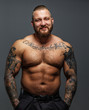 © Fxquadro - Brutal huge man with tattooes and beard smiling