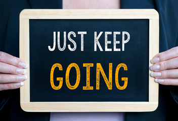 Just keep going - Businesswoman with chalkboard