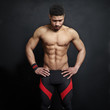 © SFIO CRACHO - Athletic man on black wall background