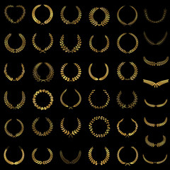 set of gold award laurel wreaths and branches on dark background