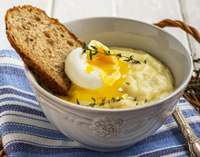 Thick Mashed Potatoes With Poached Egg And A Slice Of Bread
