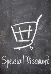 Wall Mural - special discount text and shopping cart sign on blackboard