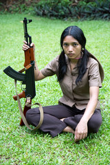 Wall Mural - Asian woman with machine gun