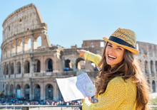 Happy Young Woman With Map Pointing On Colosseum In Rome, Italy