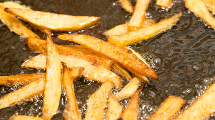 Wall Mural - French fries fried in a pan