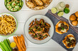 Sports feast - chicken wings, vegetable, french fries, pizza