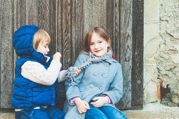 Wall Mural - Outdoor portrait of a little girl and her brother