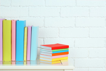 Canvas Print - Books on shelf on wall background