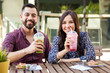 © AntonioDiaz - Pretty couple drinking smoothies during a date in a cafe