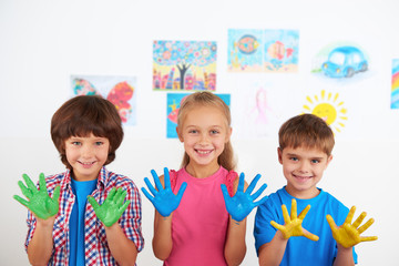 Happy children showing painted hands