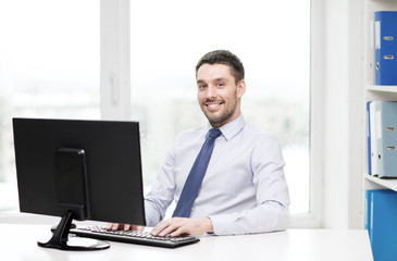 Canvas Print - smiling businessman or student with computer