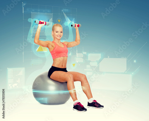 Fototapeta do kuchni woman with dumbbells sitting on fitness ball