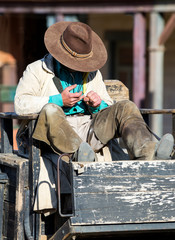 Fototapete - Cowboy sitting on a wagon at Mini Hollywood Almeria Spain