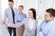 © Syda Productions - smiling business people meeting in office