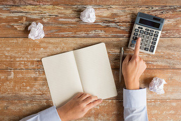 Canvas Print - close up of hands with calculator and notebook