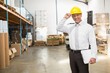© WavebreakmediaMicro - Warehouse manager wearing hard hat holding clipboard