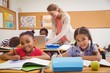 © WavebreakMediaMicro - Cute pupils drawing at desk in classroom