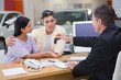 © WavebreakmediaMicro - Salesman giving car keys to a couple