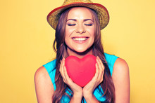 Young Woman Portrait With Closed Eyes Holding Red Heart.