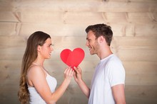 Composite Image Of Romantic Young Couple Holding Heart