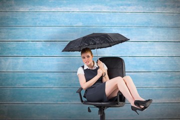 Poster - Businesswoman holding umbrella sitting on swivel chair