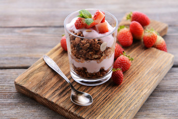 Wall Mural - Healthy layered dessert with muesli and berries on table