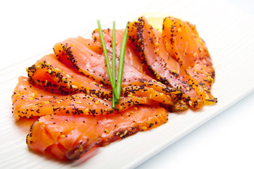 smoked salmon on white dish with chive