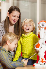 Wall Mural - Children playing and learning with robot