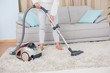 © WavebreakMediaMicro - Woman using vacuum cleaner on rug