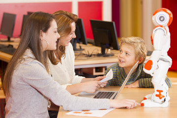 Wall Mural - Female teacher programming robot with children
