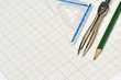 © abdrahimmahfar - Mathematical instruments and pencil on graph paper.