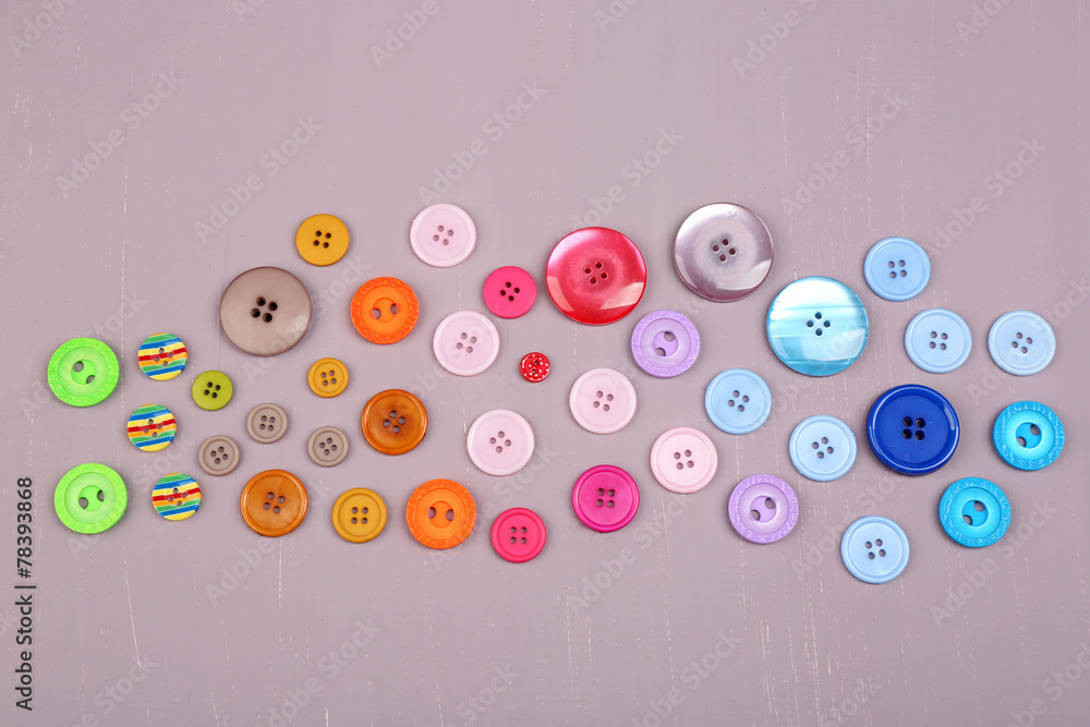 Colorful buttons on wooden background