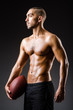 © Elnur - Muscular football player with ball