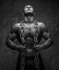 Muscular young man with chain.