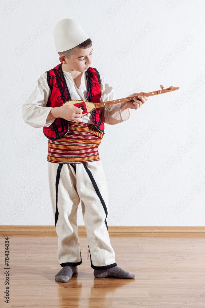 young boy playing traditional string instrument Stock Photo | Adobe Stock
