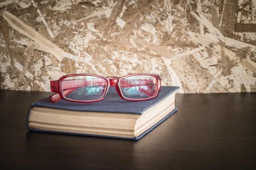 glasses and book with filter effect retro vintage style