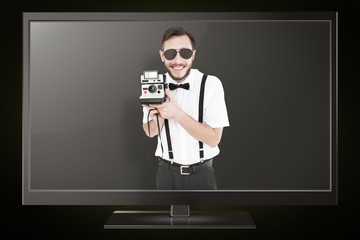 Poster - Composite image of geeky hipster holding a retro camera