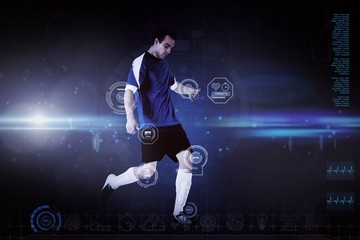 Wall Mural - Composite image of football player in blue kicking