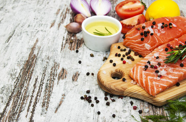 Wall Mural - portions of fresh salmon fillet with aromatic herbs, spices and