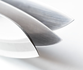 Three knives on white background